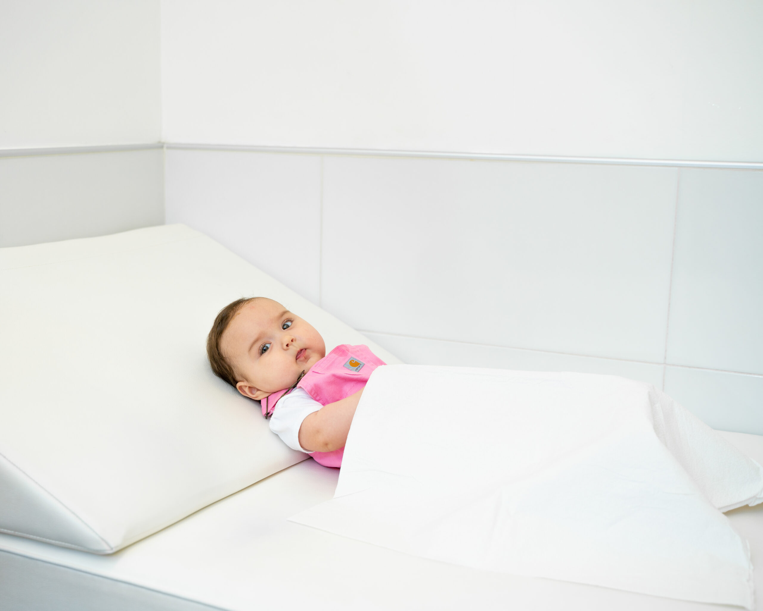 cute baby laying on bed